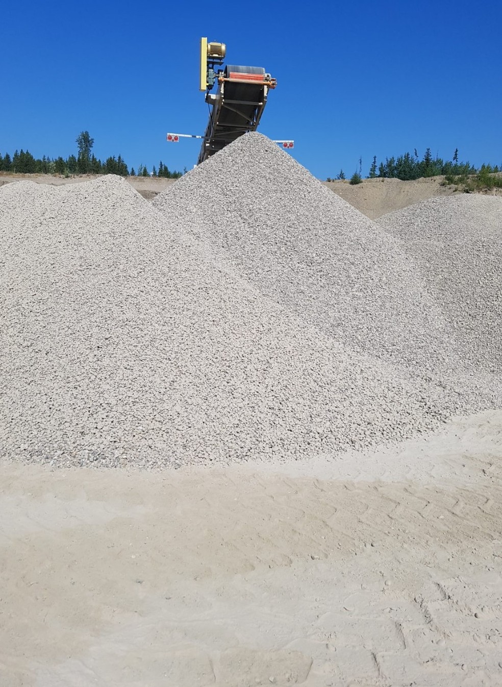 Clear crush rock piles blue sky Prince George BC